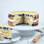Lemon and Blueberry Cake, sliced and on a cake stand.