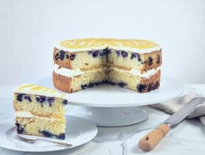 Lemon and Blueberry Cake, sliced and on a cake stand.