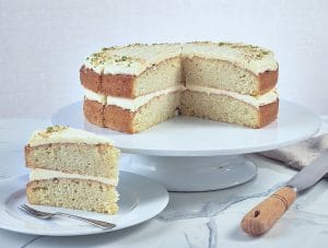 Coconut and Lime Cake sliced and on a cake stand