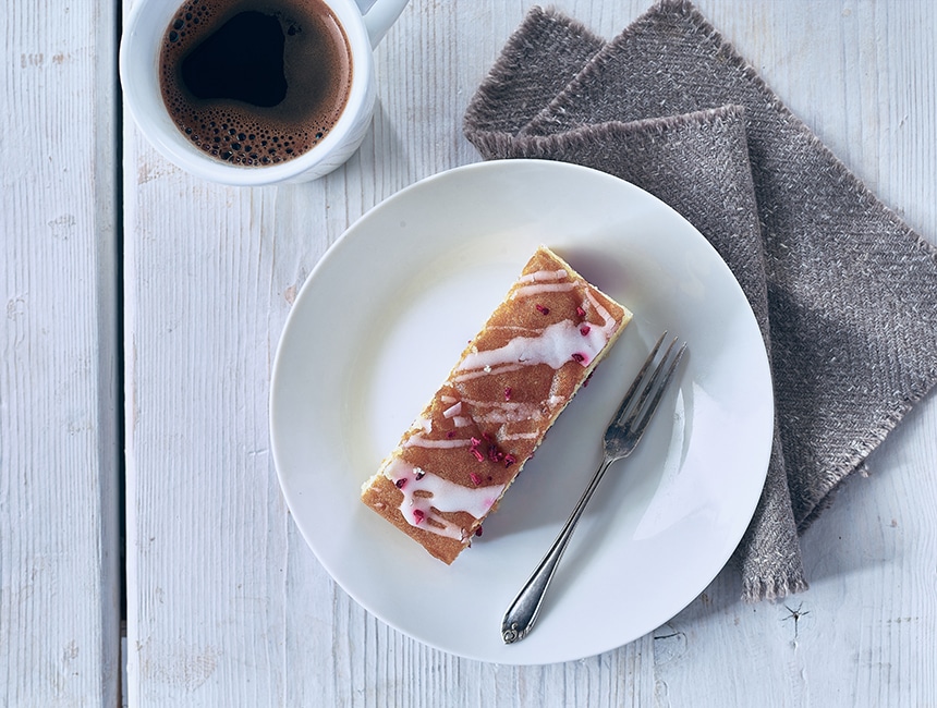 Slice of Raspberry and white blondie on a plate