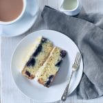 Slice of Lemon and blueberry cake on a plate from above